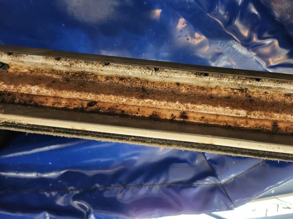 Air conditioner drain pan blocked with mould