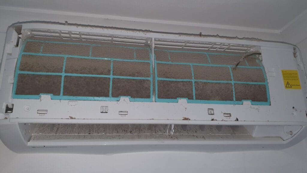 a dirty air conditioner with mould and dust