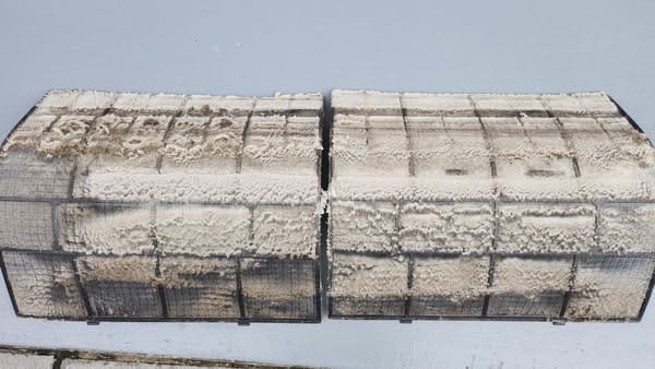 a close-up of dirty air conditioner filters