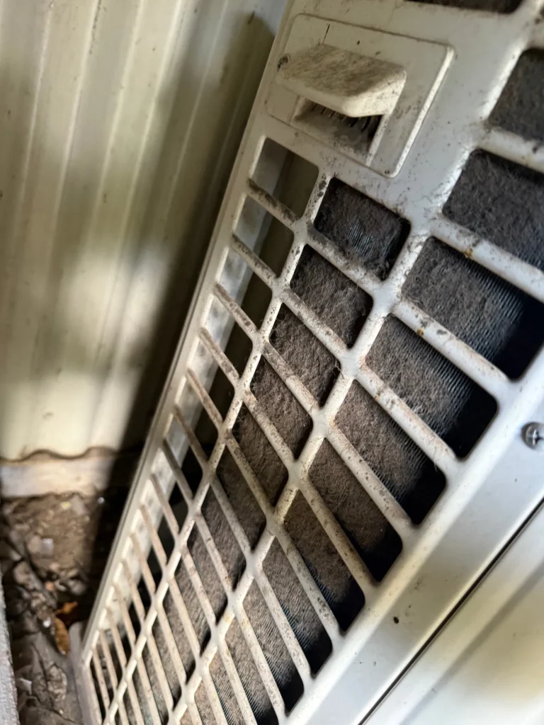 a dirty air conditioner outdoor condenser unit