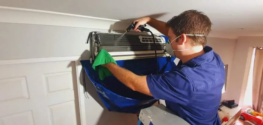 Technician cleaning a home unit